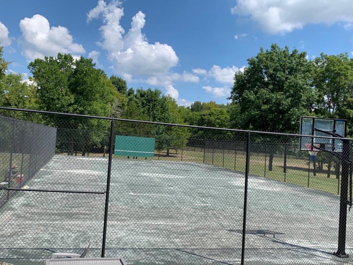Faded, worn tennis court before resurfacing