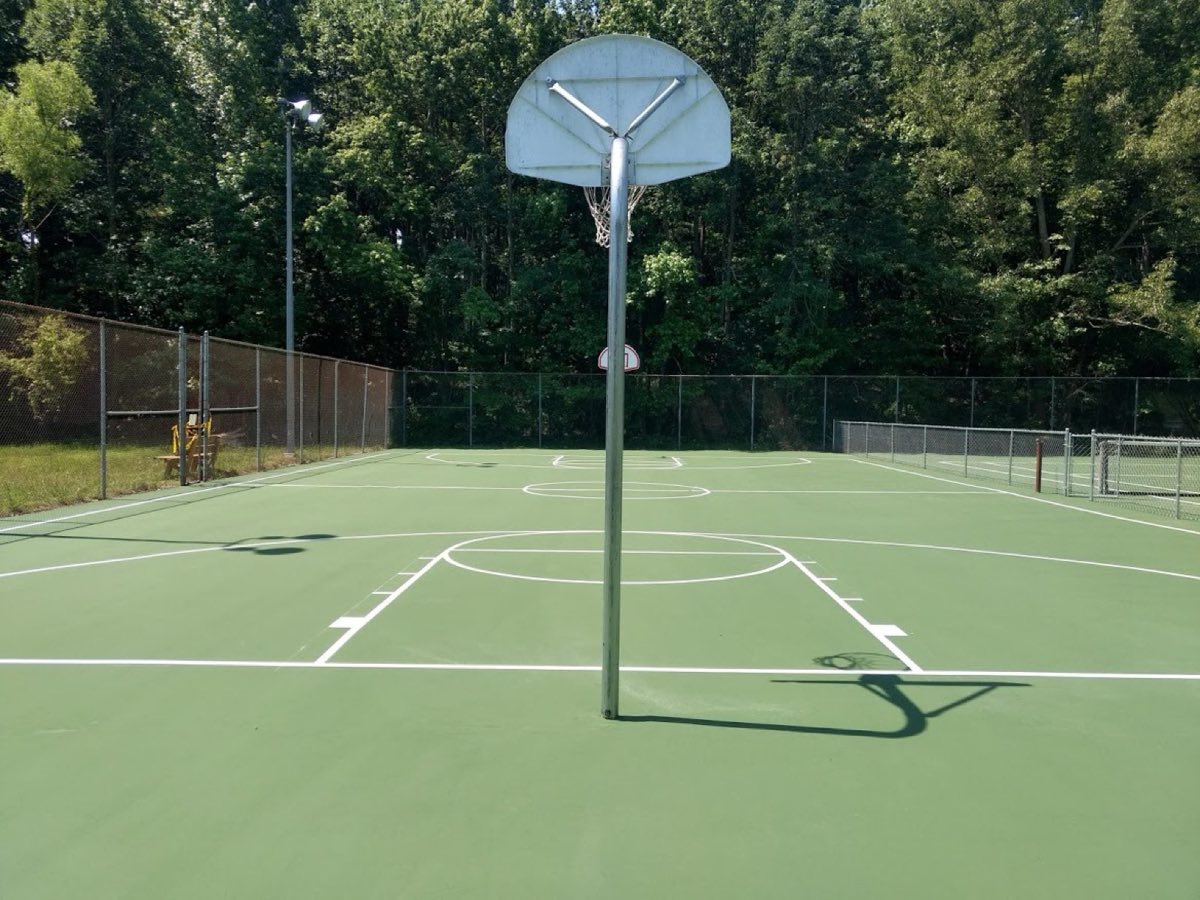 Same basketball court resurfaced in green with crisp white lines