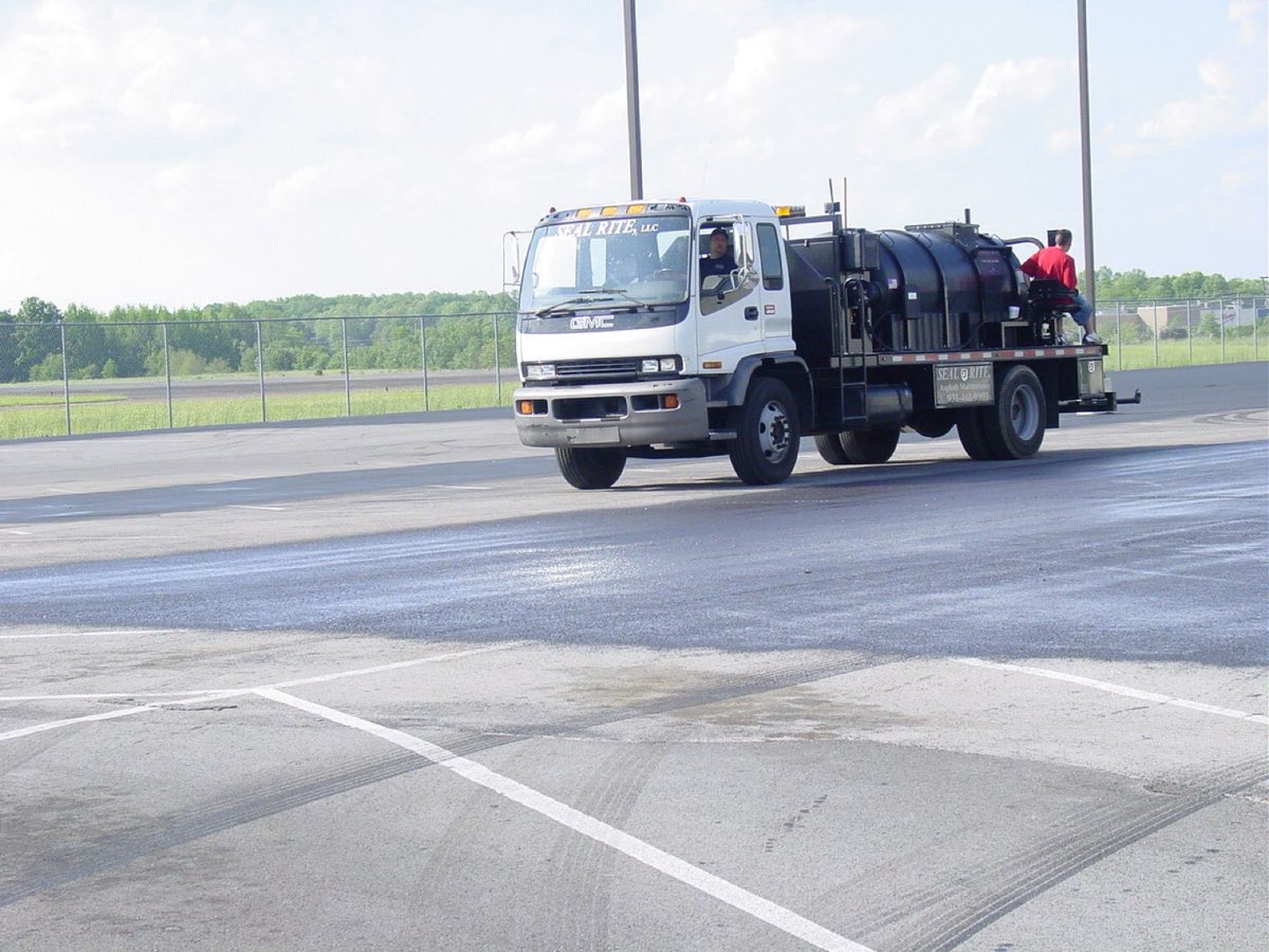 Seal Rite spray rig sealcoating a parking lot